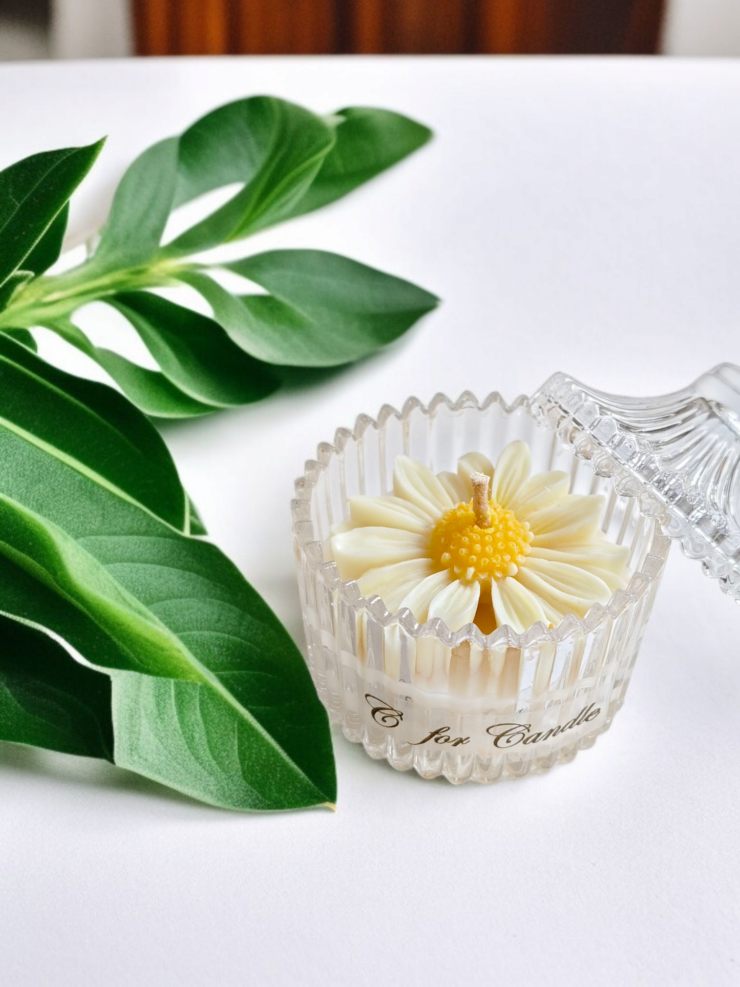 Daisy flower candle in a crystal glass jar