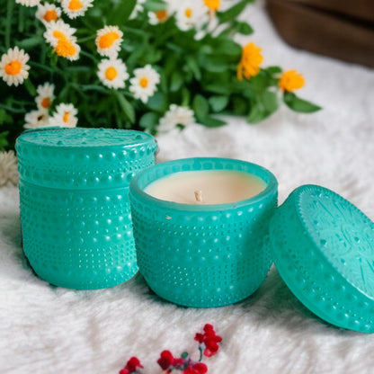 Blue dotted jar candle on a white fur mat