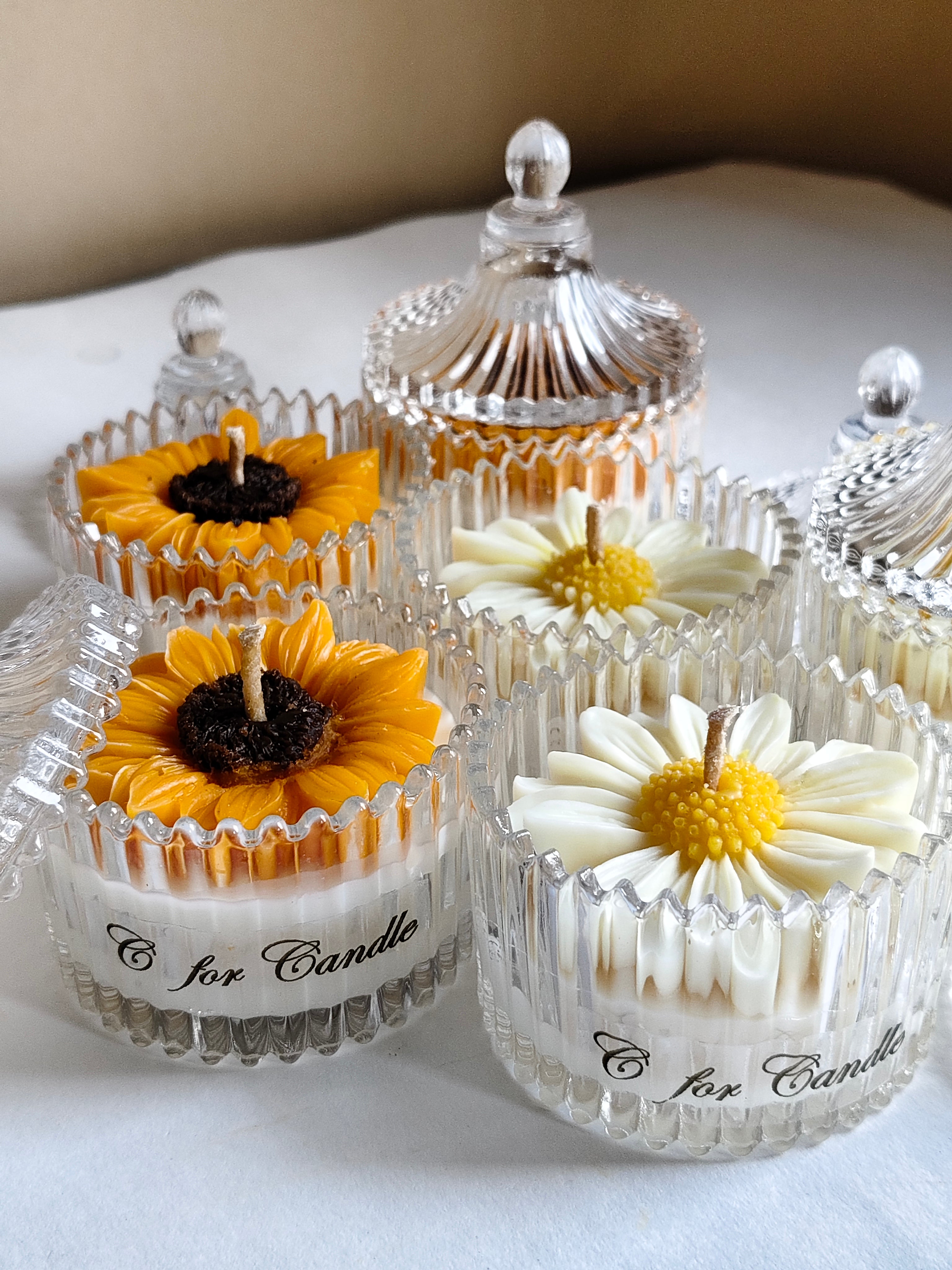 Flower candle in a crystal glass jar