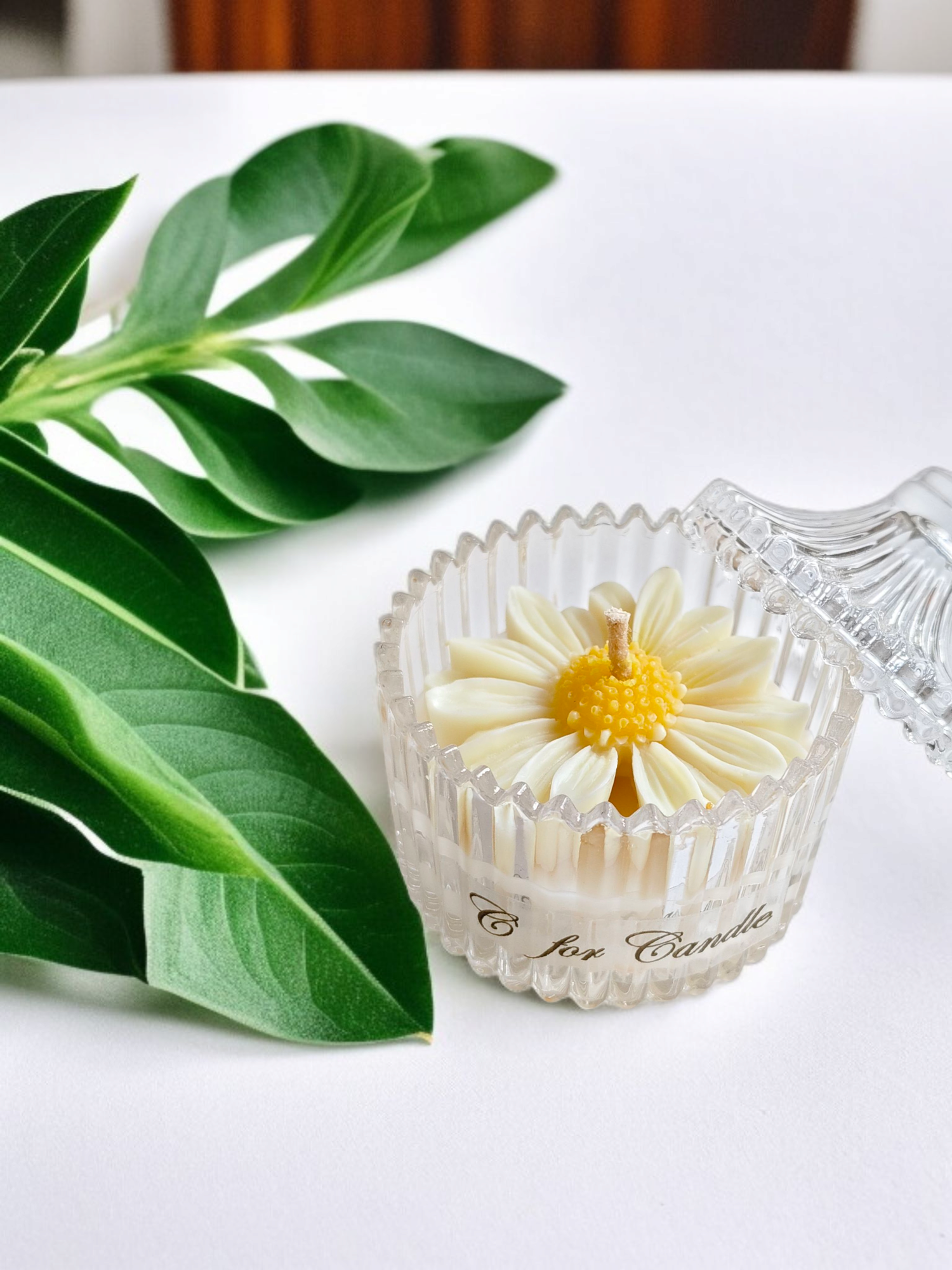 Daisy flower candle in a crystal glass jar