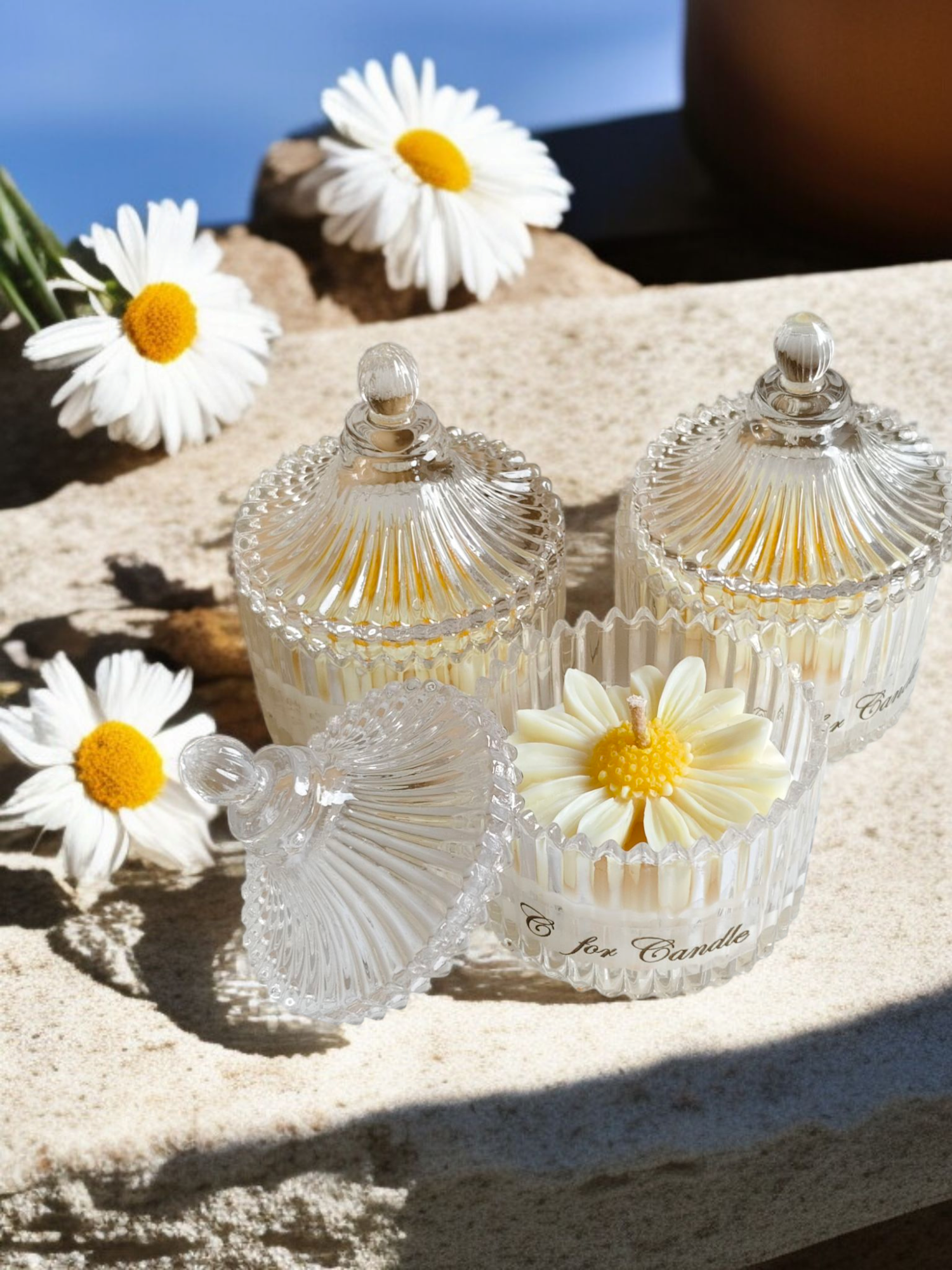 Daisy flower candle in a crystal glass jar