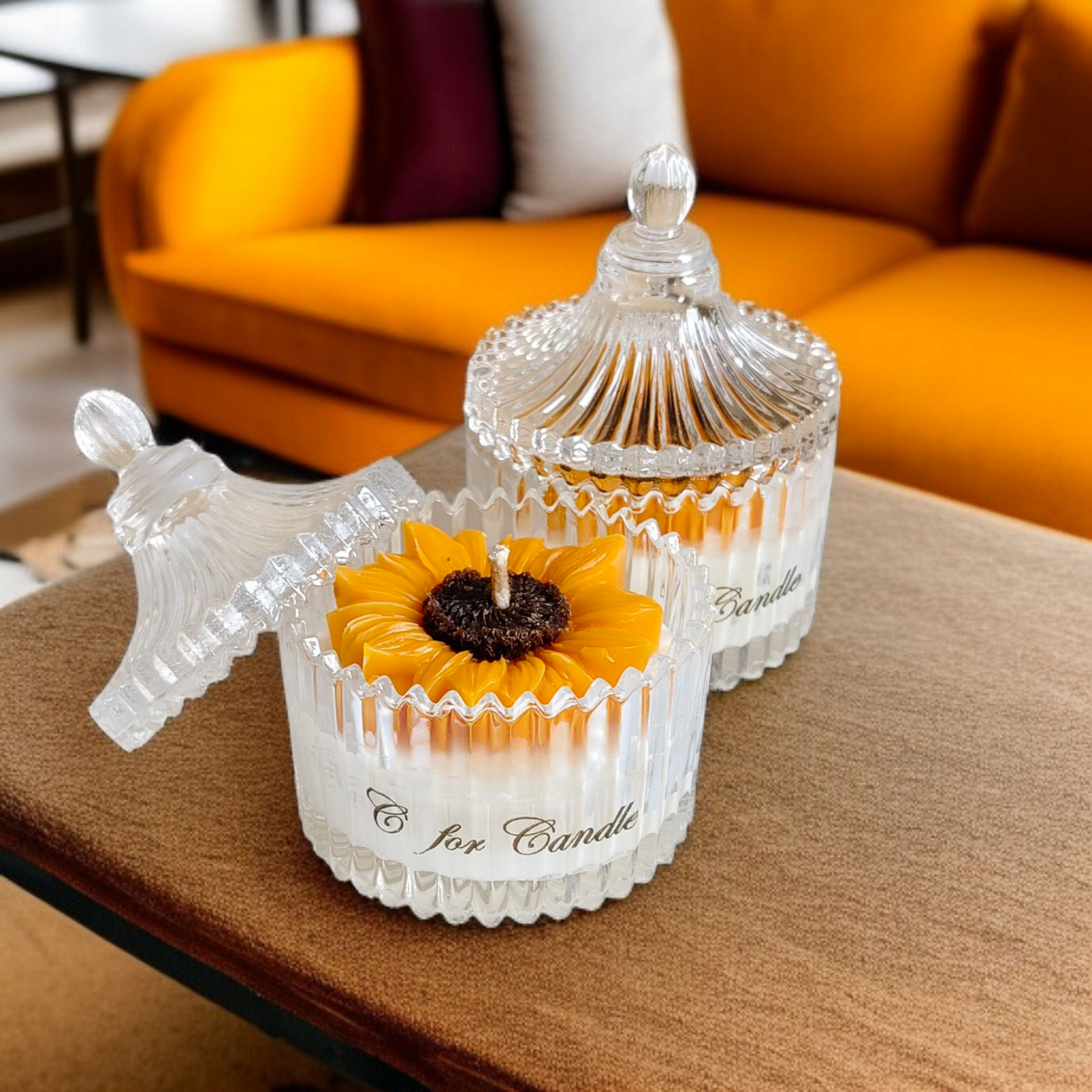 Sunflower candle in a crystal glass jar on a table